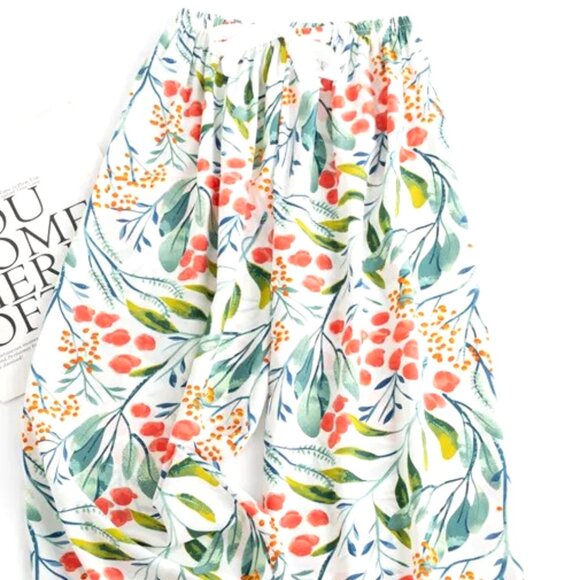 LONGER LENGTH CASUAL PANTS O/S WHITE BACKGROUND W/ORANGE FLOWERS & GREEN LEAVES - Picture 1 of 2